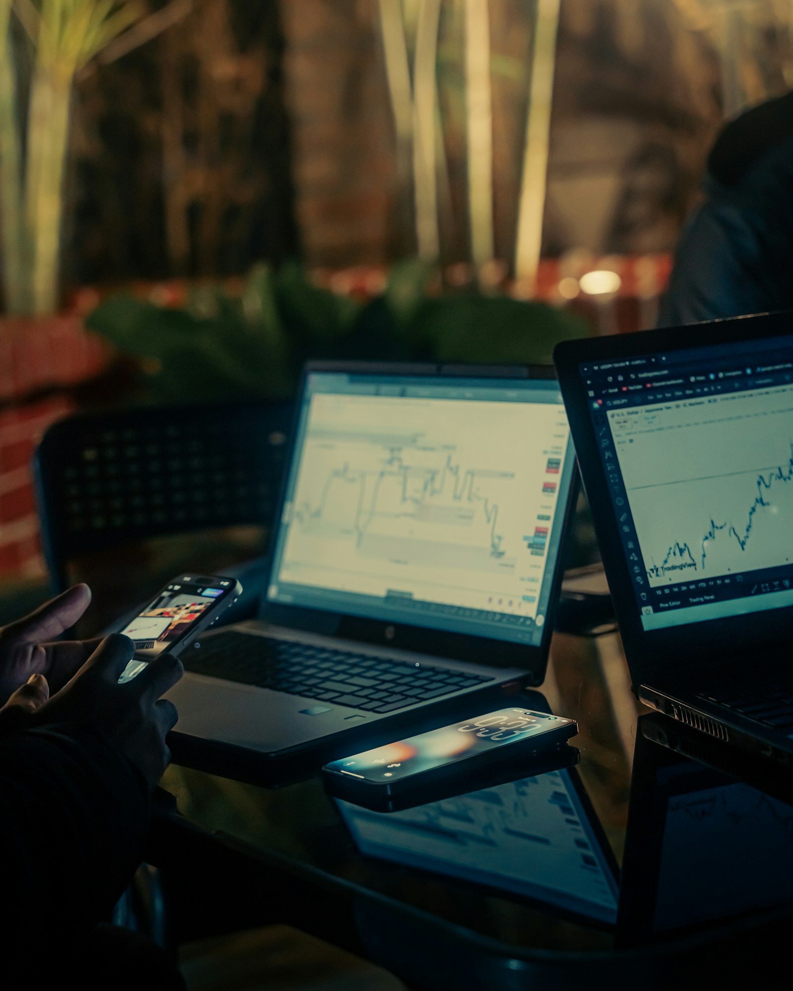 Financial chart lines glowing against a dark background.